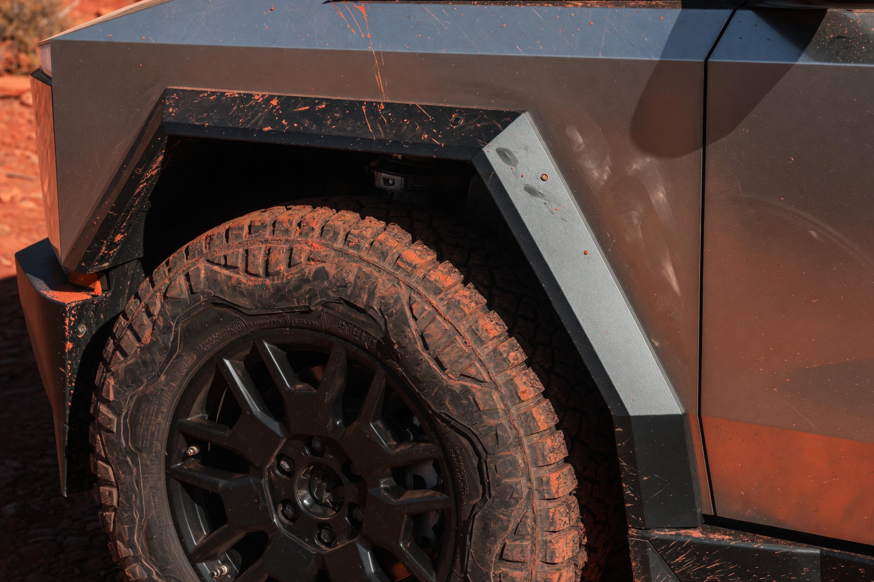 Cybertruck muddy wheel and fender, Sedona red rock trail